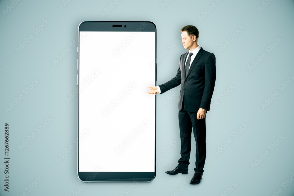 Businessman presenting a giant smartphone with blank white screen. Businessman presenting a giant smartphone with blank white screen.