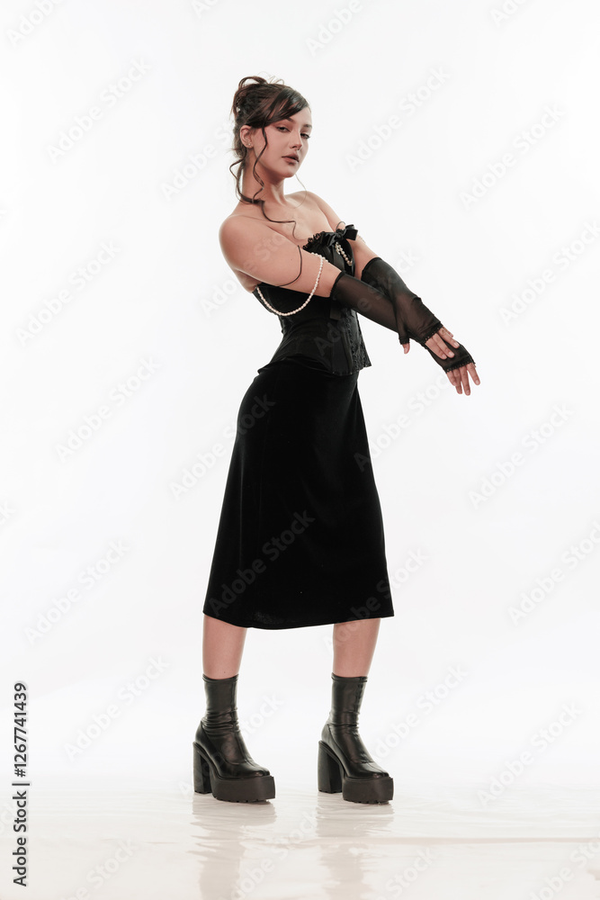 Young beautiful girl brunette of an eastern outbreak of black dress on a white background Young beautiful girl brunette of an eastern outbreak of black dress on a white background