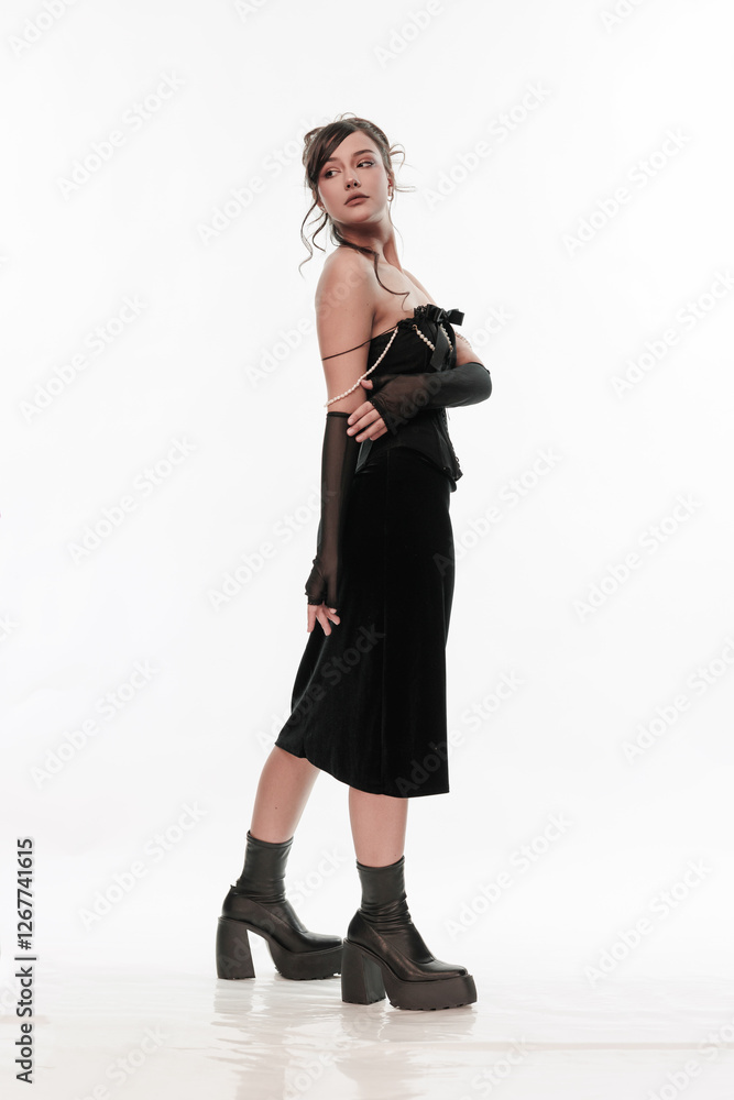 Young beautiful girl brunette of an eastern outbreak of black dress on a white background Young beautiful girl brunette of an eastern outbreak of black dress on a white background