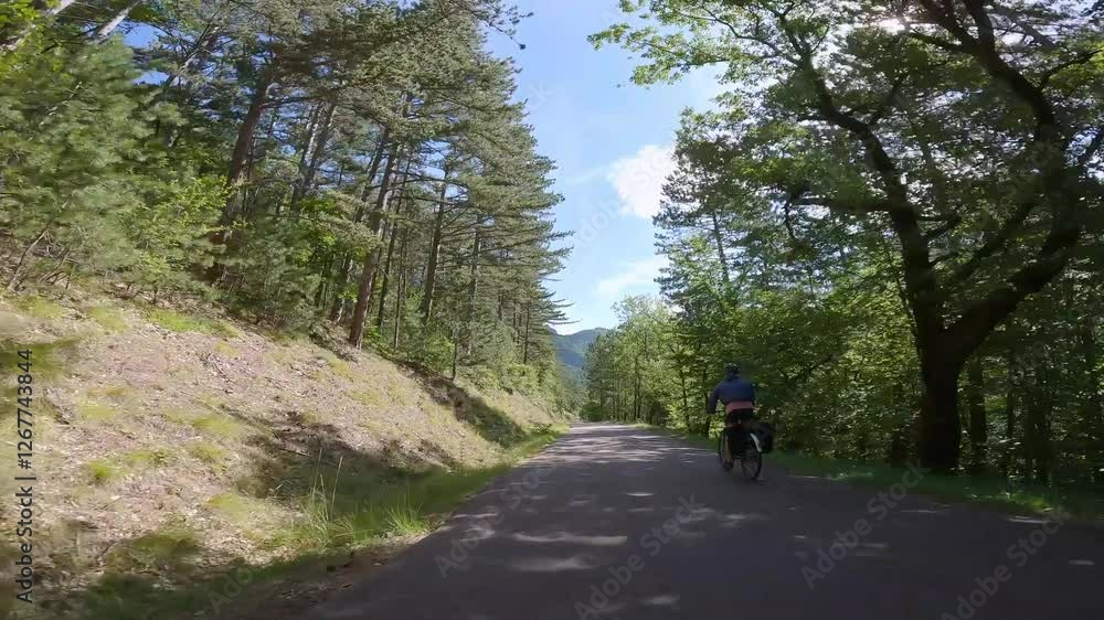 e-bike rider on a mountain road in France e-bike rider on a mountain road in France