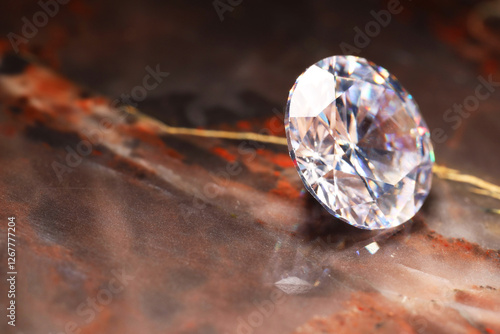 Beautiful shiny gemstone on brown marble surface, closeup. Space for text photo