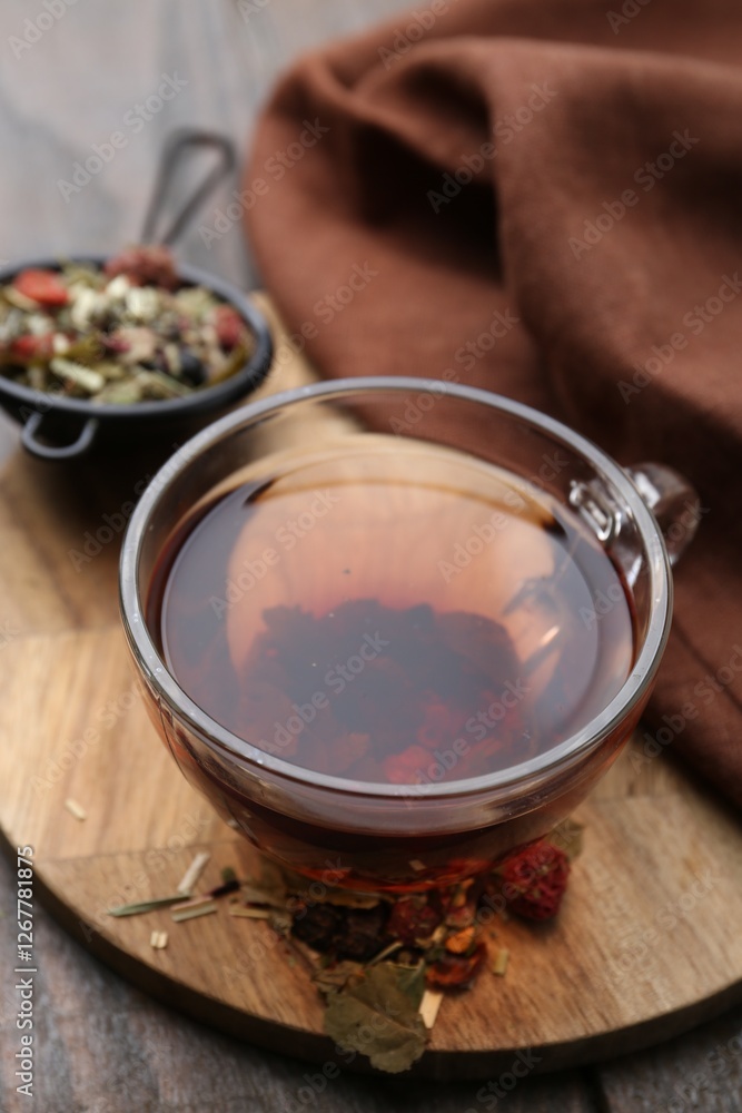 Delicious herbal tea and dry leaves on wooden table, closeup Delicious herbal tea and dry leaves on wooden table, closeup