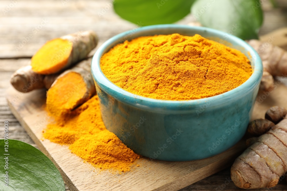 Turmeric powder in bowl and roots on table, closeup Turmeric powder in bowl and roots on table, closeup