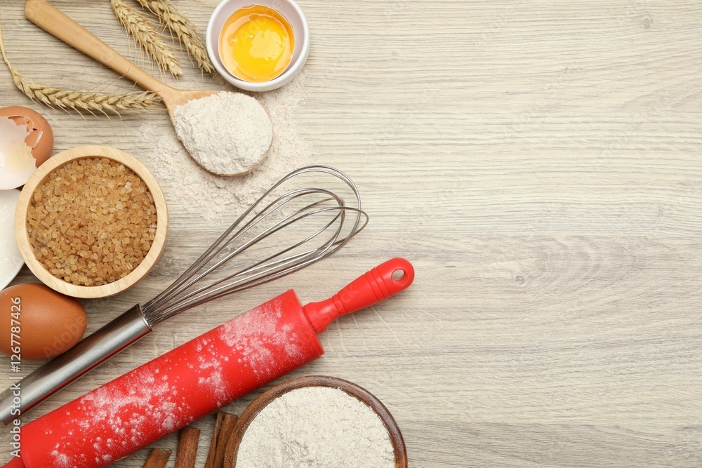 Fototapeta premium Rolling pin and different ingredients on light wooden table, flat lay. Space for text