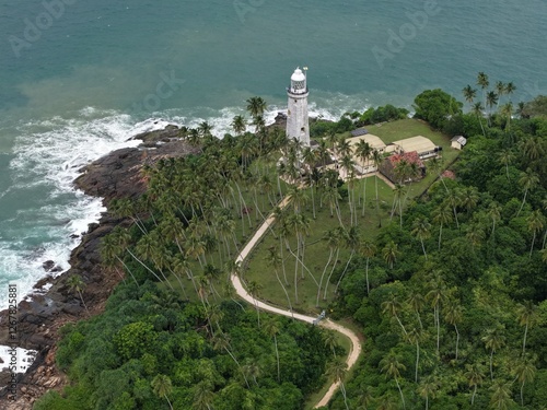 Fototapeta Naklejka Na Ścianę i Meble -  defaultAerial Drone Footage of Beruwala Lighthouse, Sri Lanka – Tropical Island & Ocean Waves