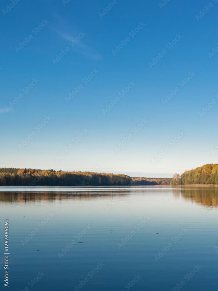 Calm lake with a blue sky in the background Calm lake with a blue sky in the background