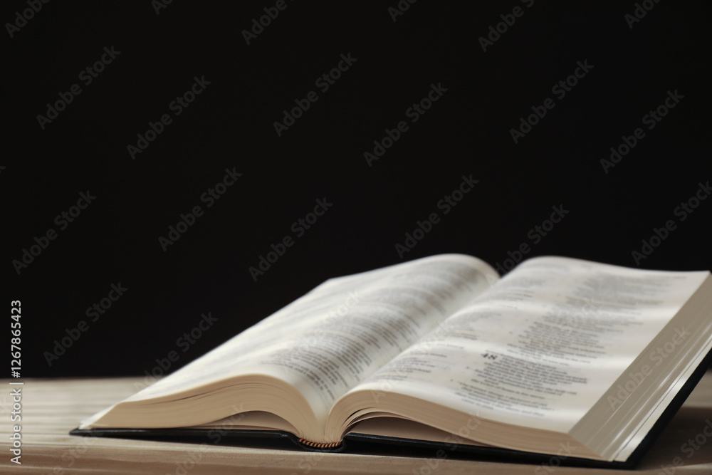 Open Holy Bible in English language on beige table Open Holy Bible in English language on beige table