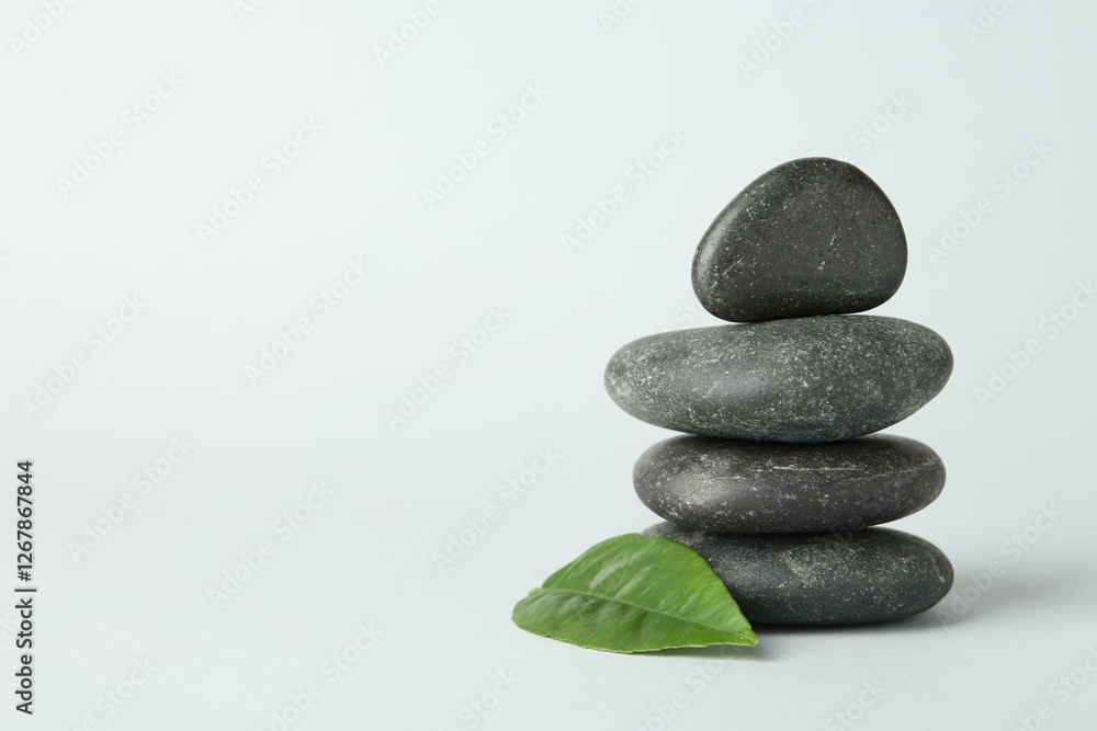 Stack of rocks on light background, space for text. Harmony and life balance Stack of rocks on light background, space for text. Harmony and life balance