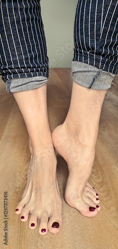 Female feet with burgundy color nails