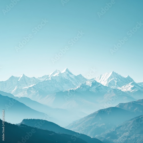 Serene Snow Mountain Peaks Landscape Majestic Peaks in Atmospheric Blue Hue Peaceful Vista photo