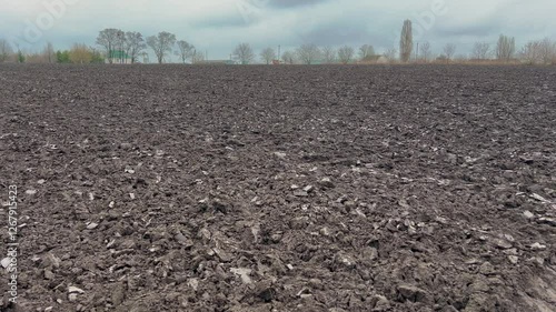 A close up of dry, cracked soil showing the rough texture and arid conditions. Beautiful black soil in a field that will support a variety of agricultural crops. Soil for growing wheat, corn, rapeseed