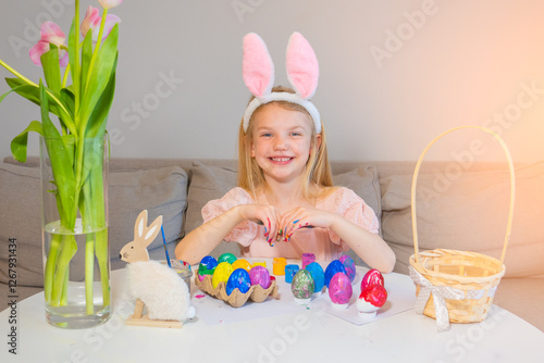 Colorful Easter egg decorating with a cheerful child in a cozy indoor setting during the holiday celebration