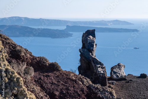 Volcanic rocks and Kameni volcano in Santorini photo