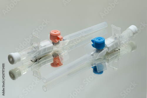 Two IV Cannulas on Glass Surface – Medical Equipment Close-Up