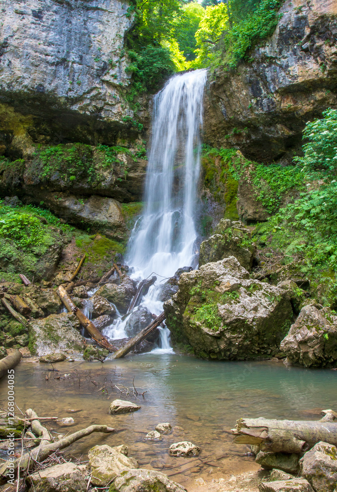 a waterfall, a fragment of a mountain river in the embrace of a stone canyon and a deep riverbed, a spring day in nature a waterfall, a fragment of a mountain river in the embrace of a stone canyon and a deep riverbed, a spring day in nature