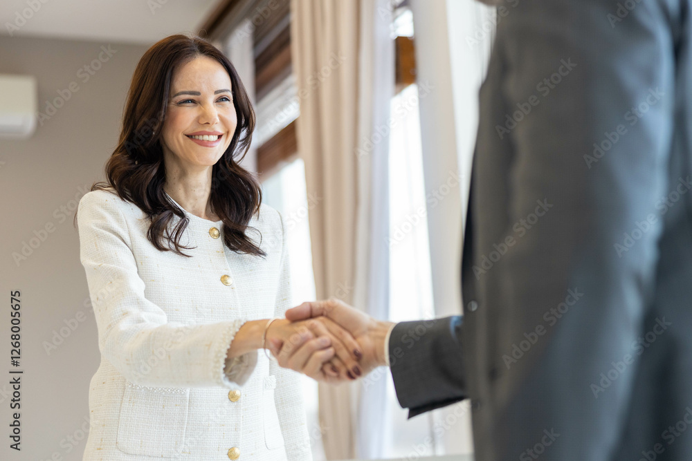 A happy businessman engages in a handshake, portraying a positive business encounter and encouraging professional relationships. A happy businessman engages in a handshake, portraying a positive business encounter and encouraging professional relationships.