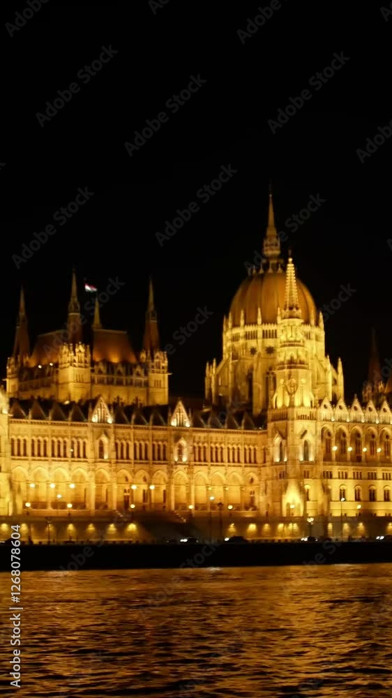 The illuminated Hungarian Parliament building shines at night, showcasing its architecture The illuminated Hungarian Parliament building shines at night, showcasing its architecture