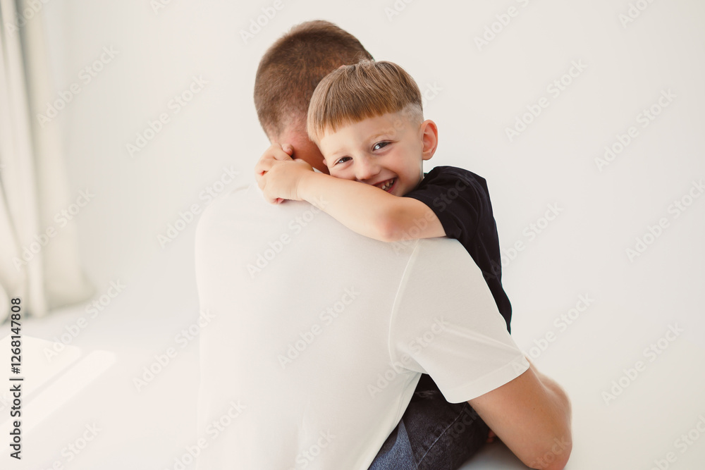 A heartwarming FatherSon moment beautifully captured in a bright, cheerful studio setting A heartwarming FatherSon moment beautifully captured in a bright, cheerful studio setting
