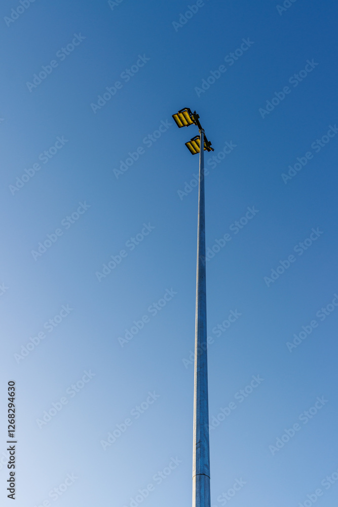 Suburban football/soccer floodlight set against a bright blue sky. Suburban football/soccer floodlight set against a bright blue sky.