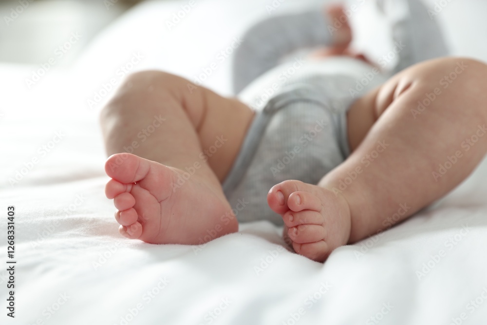 Little baby lying on bed indoors, closeup