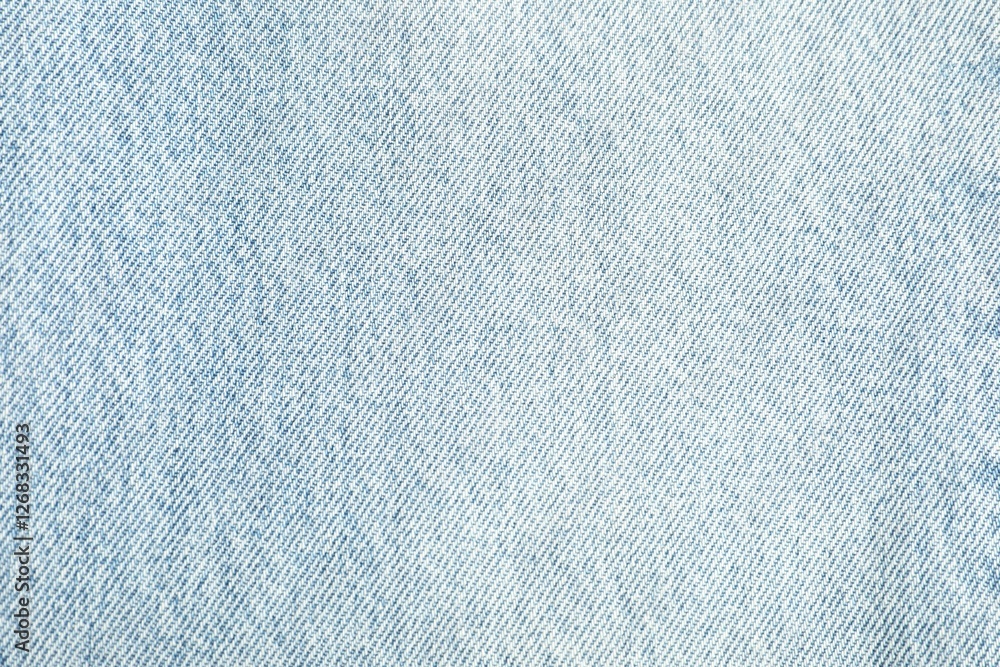 Fototapeta premium Texture of light blue jeans as background, top view