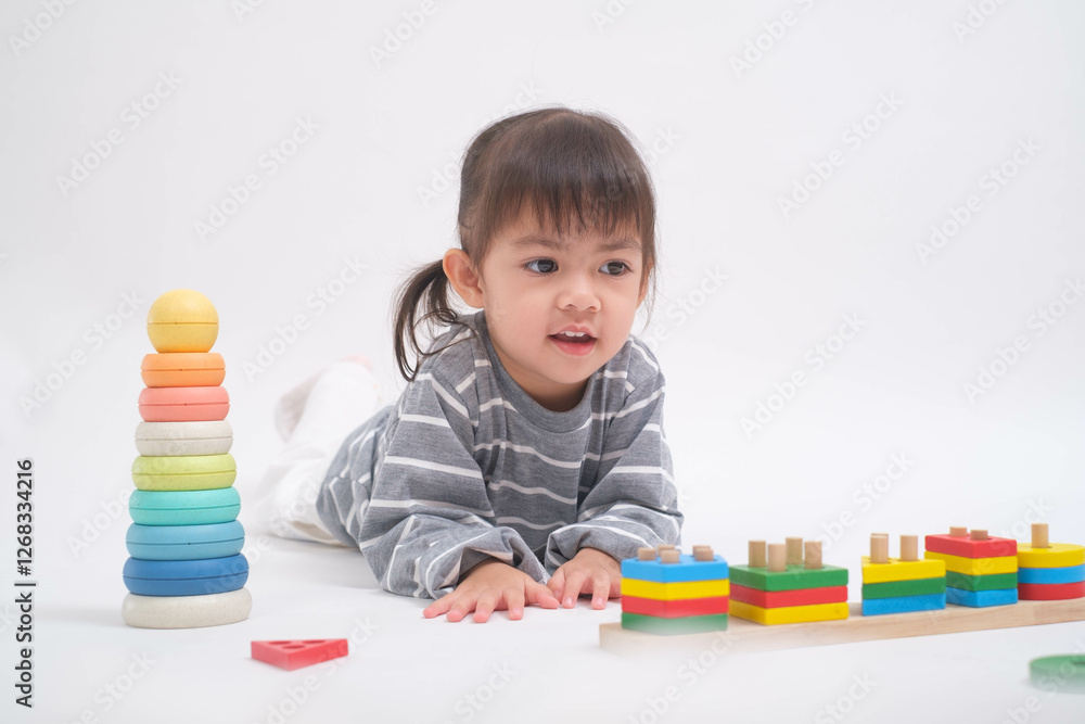 A young child engaged in play with colorful educational toys, fostering creativity and learning in a bright setting. A young child engaged in play with colorful educational toys, fostering creativity and learning in a bright setting.