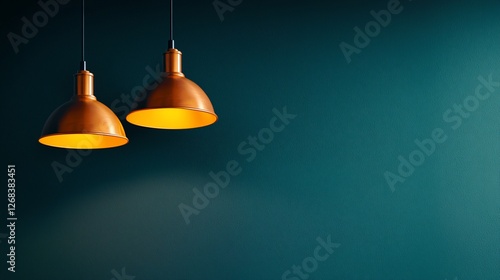 Two copper pendant lights illuminating a teal wall.