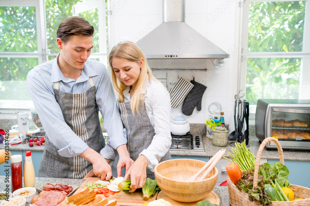 Smile and happy Caucasian young lover Cooking homemade food in kitchen.