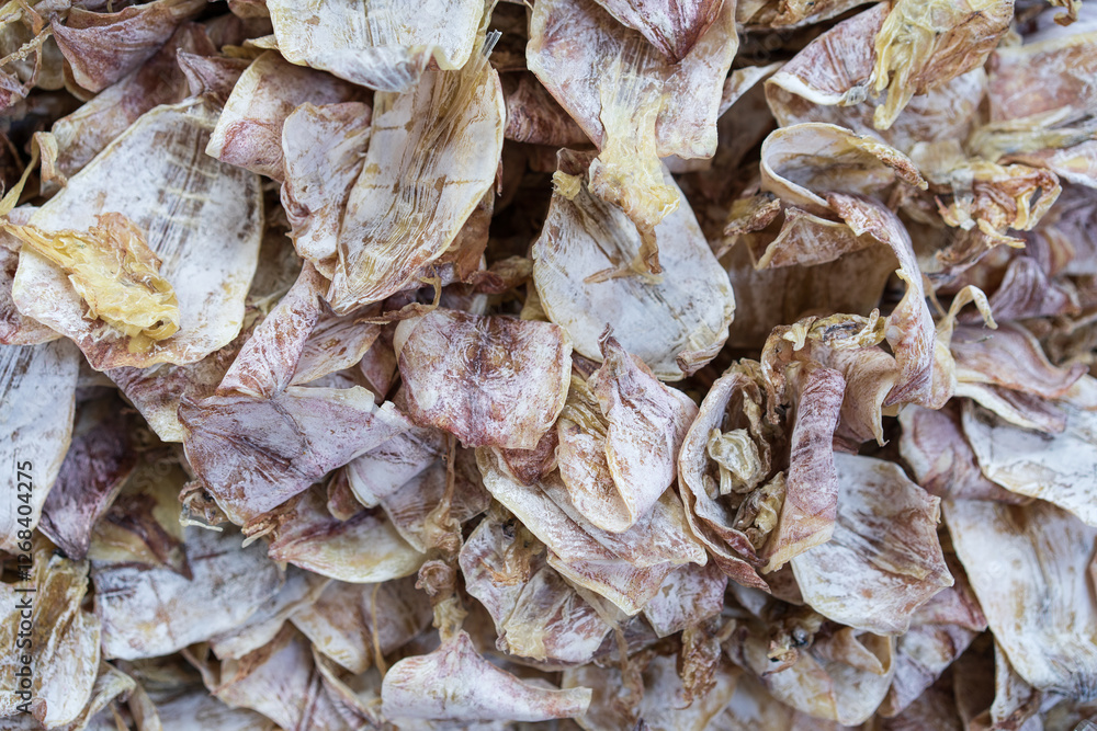 closeup dried squid pile or fresh or raw and many rare squids to dry seafood for iodine food in street fishing market at thailand