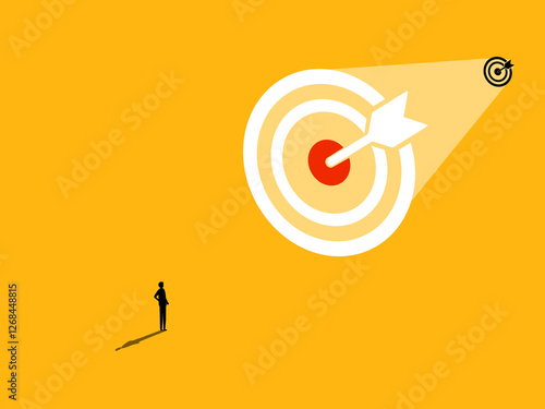 Businessman standing looking at big goal, success oriented concept