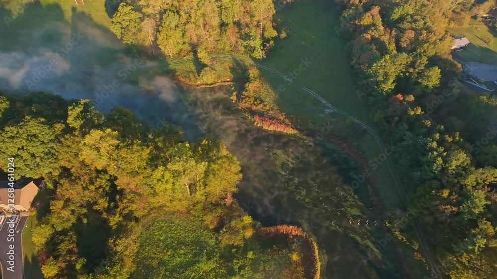 Aerial View of Scenic Landscape in Johnson City, Tennessee Overhead drone shot of lush greenery, winding path, and morning mist in Johnson City, Tennessee, showcasing natural beauty and tranquility. Aerial View of Scenic Landscape in Johnson City, Tennessee Overhead drone shot of lush greenery, winding path, and morning mist in Johnson City, Tennessee, showcasing natural beauty and tranquility.