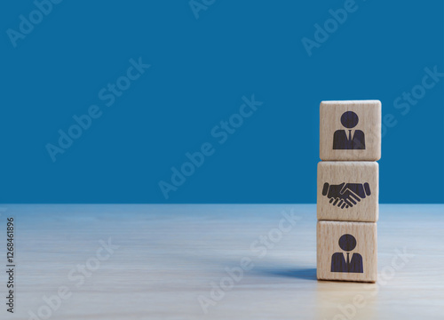Collaborate, make a deal, join a company. Businessman handshake icon on wooden blocks