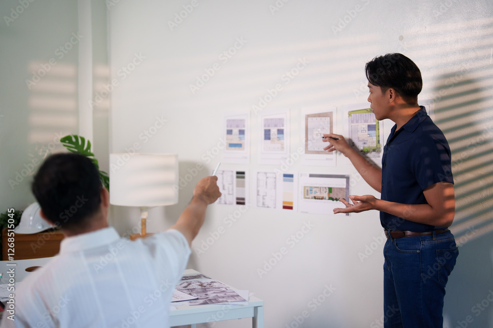 Obraz premium A group of engineers reviewing structural designs and material specifications at a meeting table