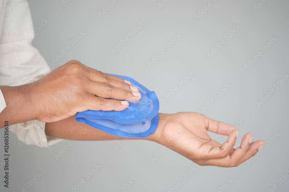 Applying a cold pack to soothe an arm injury during rehabilitation Applying a cold pack to soothe an arm injury during rehabilitation