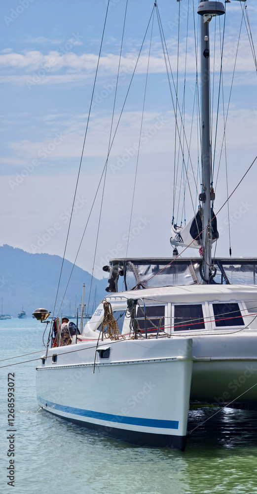 Fototapeta premium A beautiful white sailing boat gracefully through the water