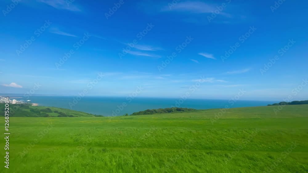 English countryside near Eastbourne, East Sussex, United Kingdom, featuring lush green fields blending into the serene coastline and tranquil blue sea under a bright sky English countryside near Eastbourne, East Sussex, United Kingdom, featuring lush green fields blending into the serene coastline and tranquil blue sea under a bright sky