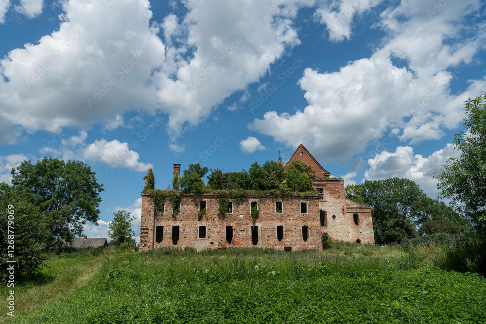 Fototapeta premium The ruins of the Roman Catholic Carmelite monastery and the Church of the Immaculate Conception of the Virgin Mary in the village of Kysylyn, Volyn region, Ukraine, July 10, 2023