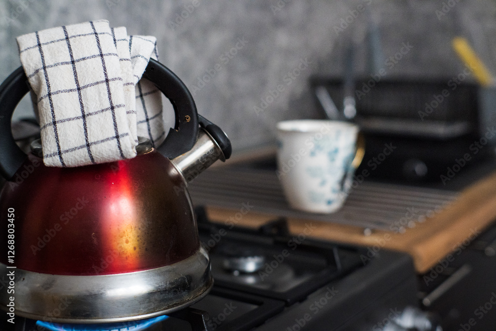 Boiling water in a kettle on a gas stove.