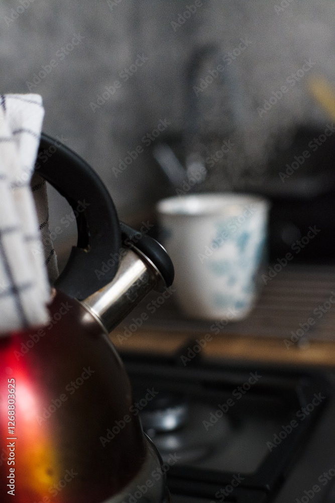 Boiling water in a kettle on a gas stove.
