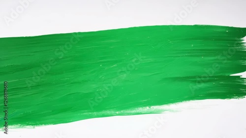 Green paint brushstroke on canvas progression: smooth artistic motion unfolds