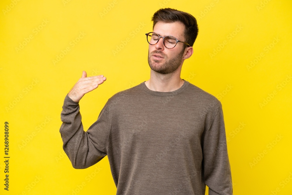 Young caucasian man isolated on yellow background with tired and sick expression Young caucasian man isolated on yellow background with tired and sick expression