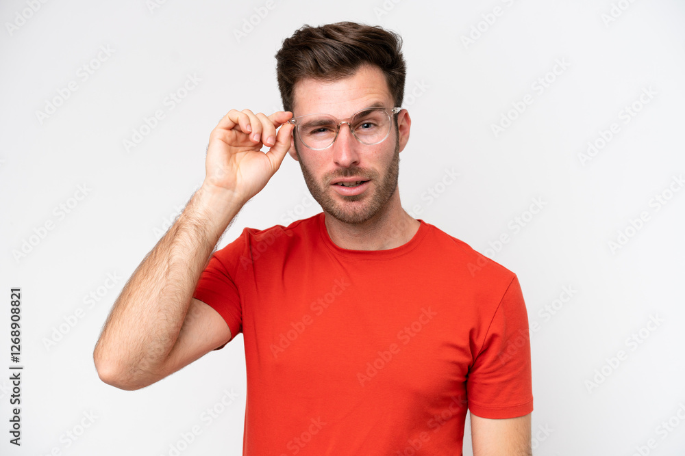 Young caucasian man isolated on white background With glasses and frustrated expression Young caucasian man isolated on white background With glasses and frustrated expression