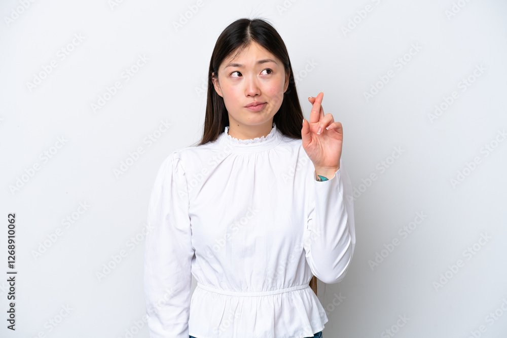 Young Chinese woman isolated on white background with fingers crossing and wishing the best Young Chinese woman isolated on white background with fingers crossing and wishing the best