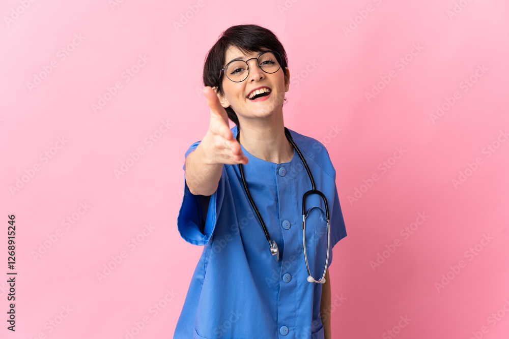 Surgeon isolated on pink background shaking hands for closing a good deal Surgeon isolated on pink background shaking hands for closing a good deal
