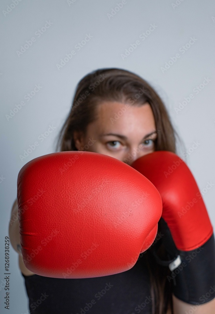 Close-up of a boxer girl with red gloves. Boxing concept and sport Close-up of a boxer girl with red gloves. Boxing concept and sport
