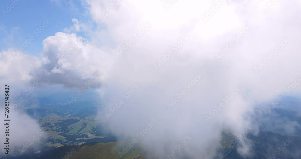 View of clouds over mountain peaks and valleys. Concept of beauty of nature. View of clouds over mountain peaks and valleys. Concept of beauty of nature.