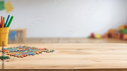 Wood Desk for Child or Kindergarten Interior Concept, Wooden desk with colorful puzzle pieces laid out in a kindergarten classroom setting