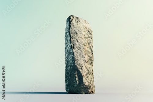 Single upright rectangular stone pillar standing against a gradient backdrop photo