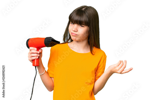 Little Caucasian girl holding a hairdryer over isolated background making doubts gesture while lifting the shoulders photo