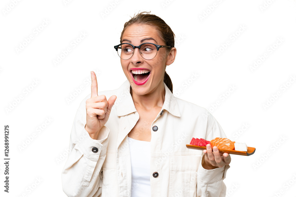 Young caucasian woman holding sashimi over isolated background intending to realizes the solution while lifting a finger up Young caucasian woman holding sashimi over isolated background intending to realizes the solution while lifting a finger up